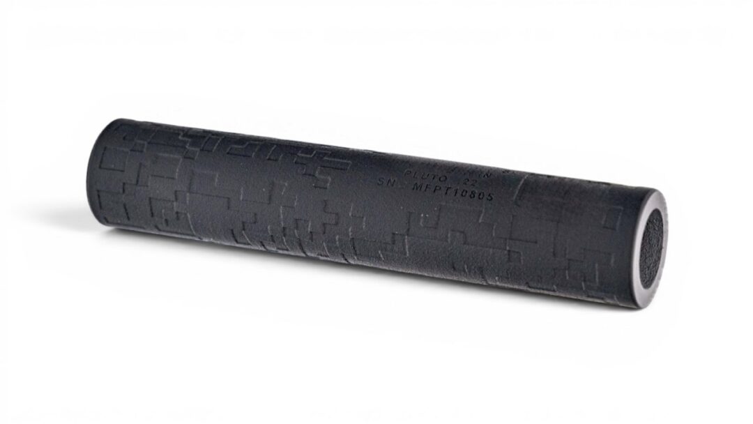 Black textured foam roller, cylindrical exercise prop with raised square pattern against a white background, used for muscle massage.