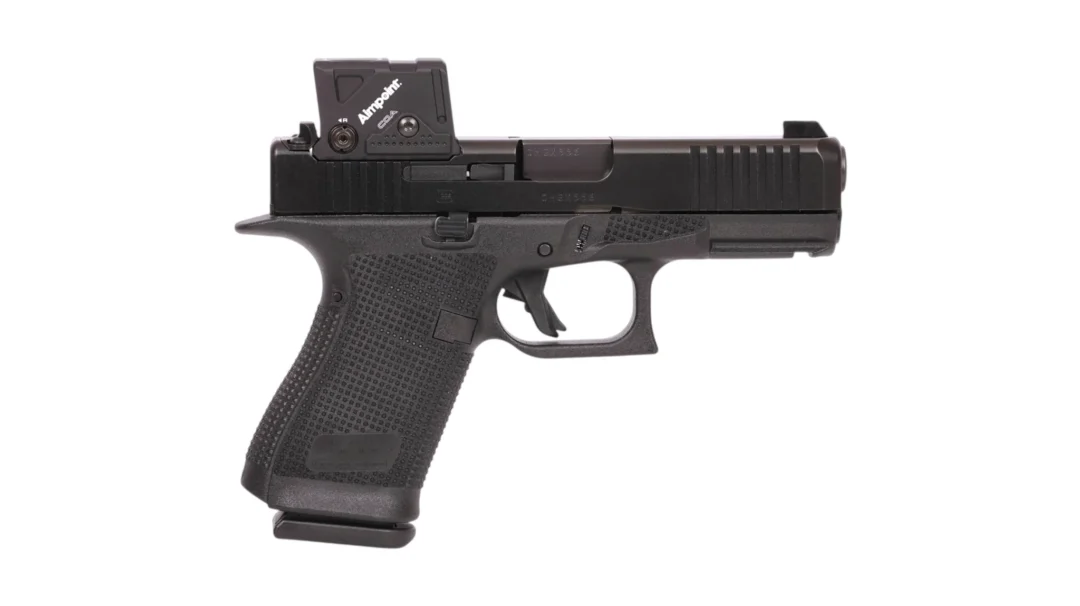 Black semi-automatic pistol with a textured grip and a mounted red-dot sight on top of the slide.