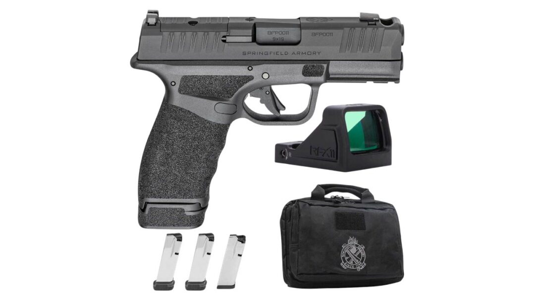 Semi-automatic pistol with textured grip, three magazines, a red-dot sight, and a black carrying case.