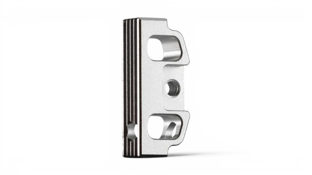 Metal mounting bracket with two rounded cutouts and a central hole, standing on a white background (informative component).