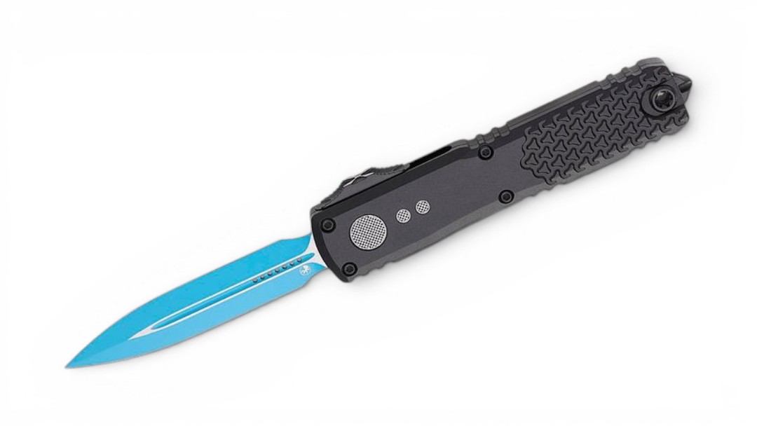 Folding knife with a bright blue blade partially extended from a black textured handle against a white background.] ,