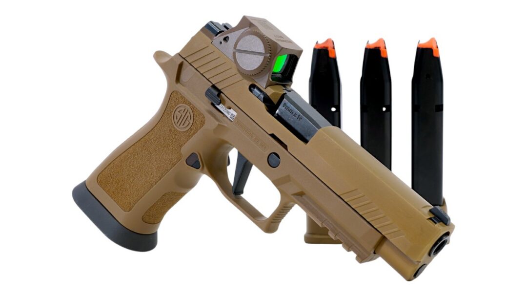 Tan semi-automatic handgun with a mounted optic and three orange-tipped magazines standing upright behind it.