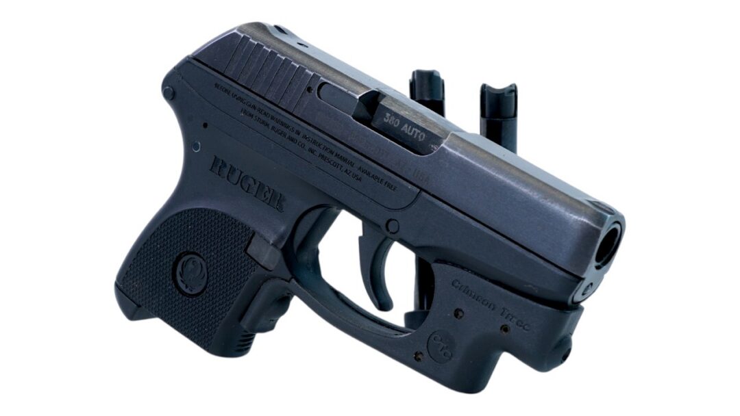 Compact black semi-automatic pistol with two magazines attached, shown from a side view on a white background, grip marked Ruger.